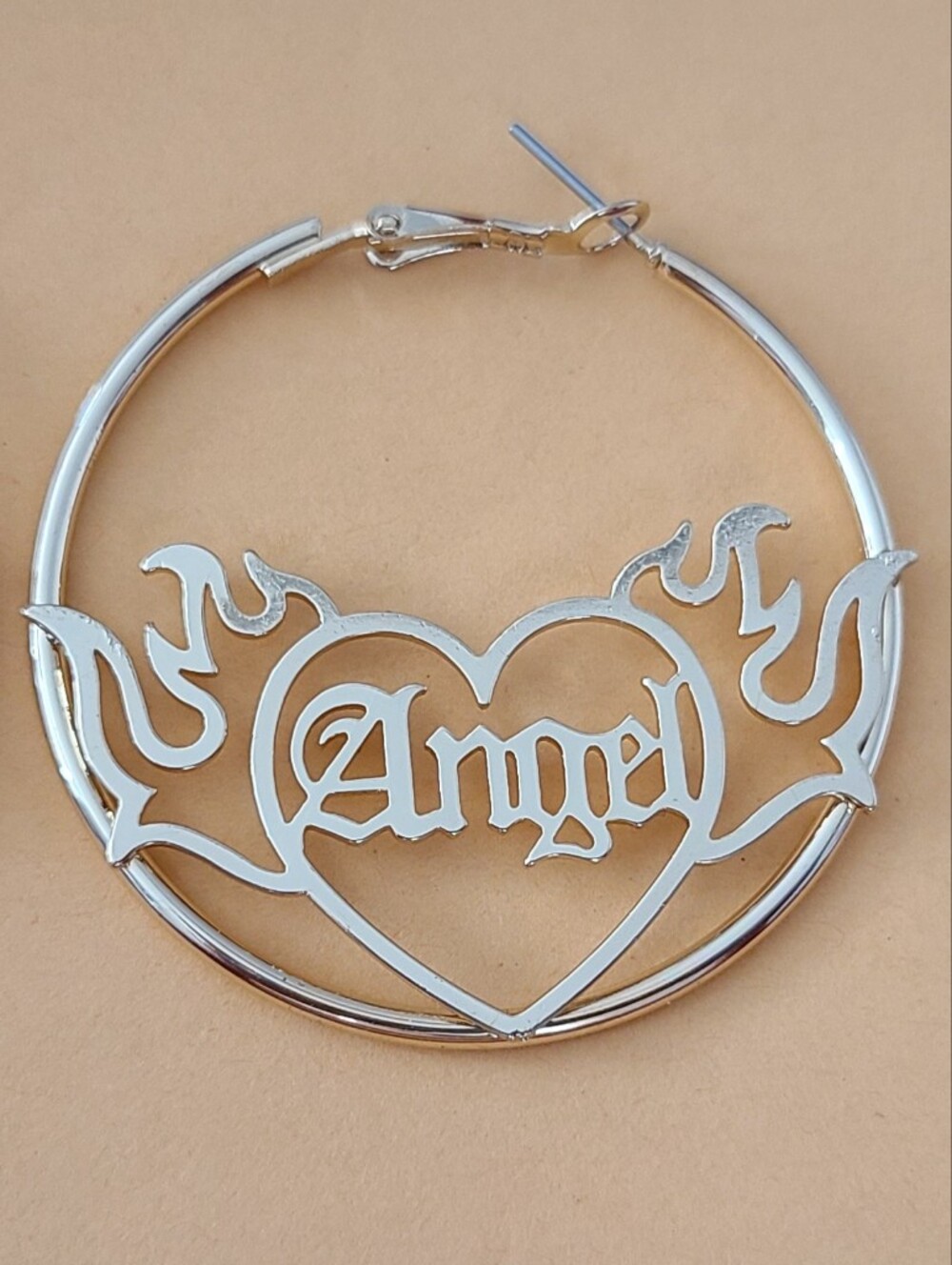 Gold-tone "Angel" script hoop earrings feat. a distinctive flaming heart Design